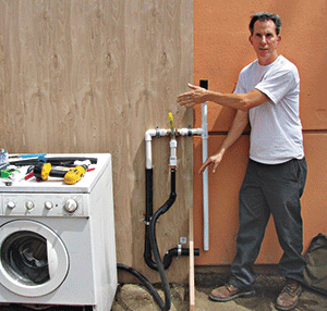 Leigh Jerrard, principal of Greywater Corps, points to one residential graywater system his company installed. Photo: Greywater Corps