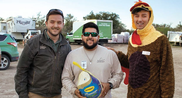 Gobble, gobble! At Summit Landscape and Design, Hondo, Texas, the company president, Josiah Peterson (left), gets the help of a feathered friend to hand out turkeys to his employees in honor of the Thanksgiving holiday. (Photo: Summit Landscape and Design)