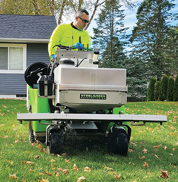 Tech operating spreader-sprayer (Photo: Left Side Lawn Care)
